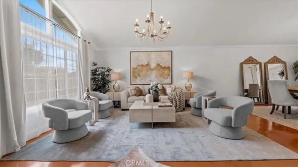 a living room with furniture and a chandelier