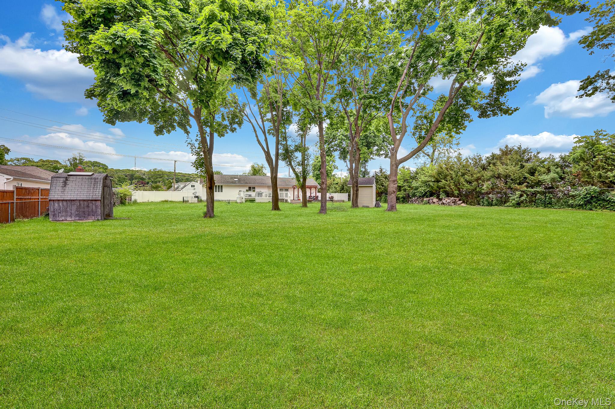 98 Granny Road Farmingville, NY 11738 - Photo 24 of 24 a huge green field with lots of trees