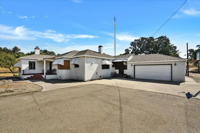 a view of a house with a yard covered in snow