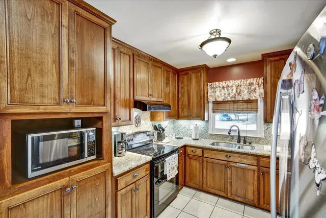 a bedroom with a bed and a flat screen tv with wooden floor