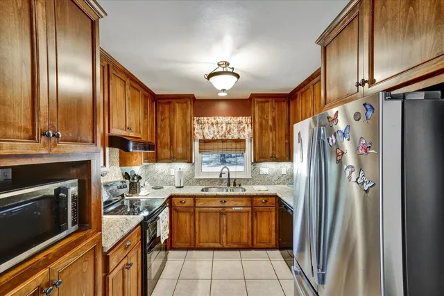 a bathroom with a granite countertop toilet sink and mirror