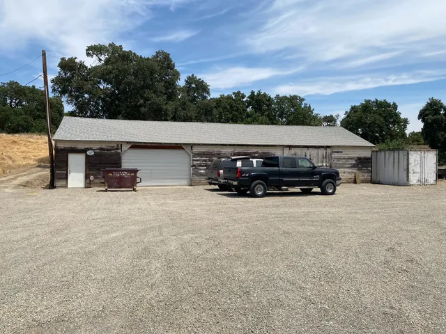 a view of a lake with beach and mountain in the back