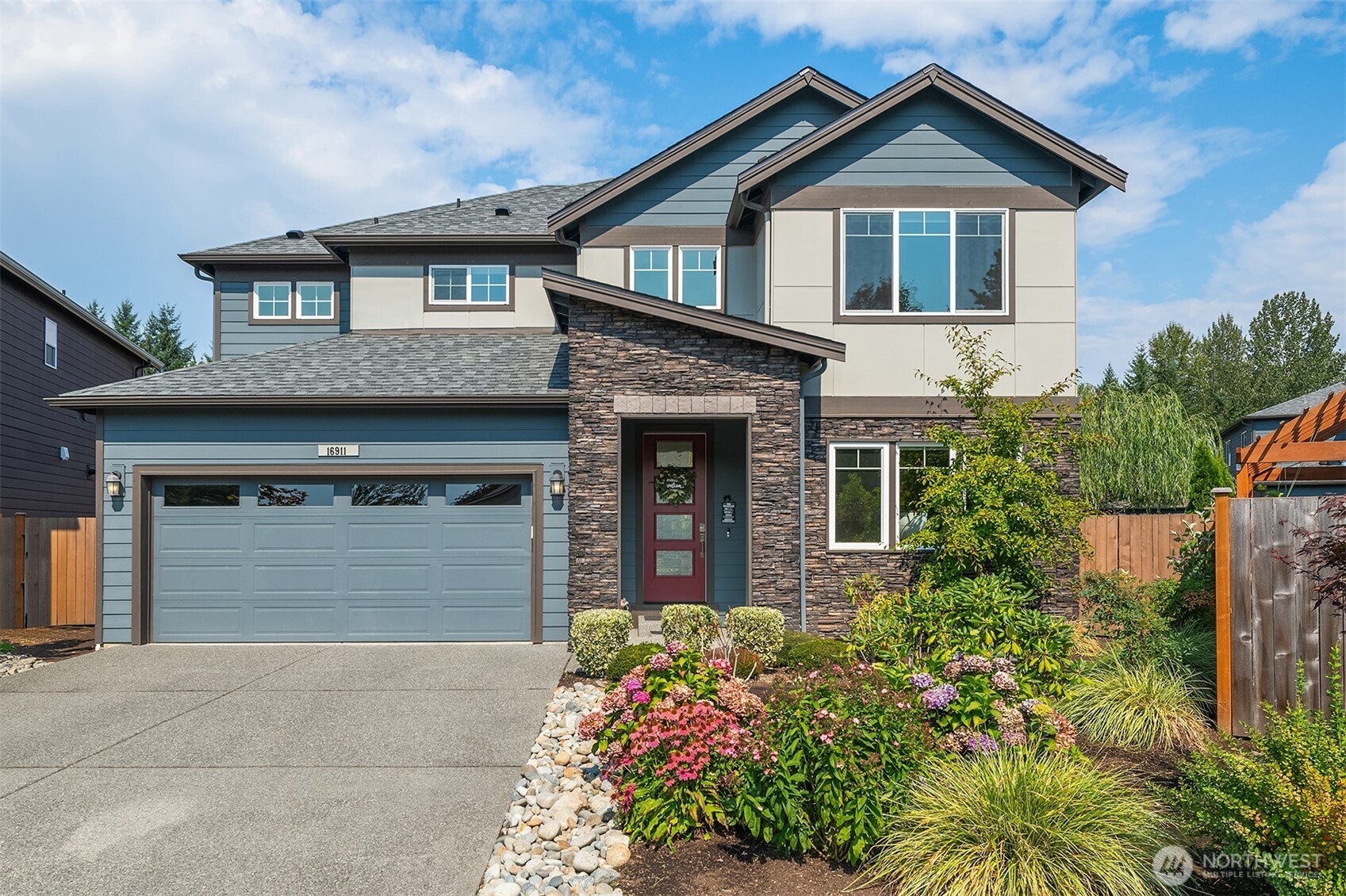 a front view of a house with a yard and garage