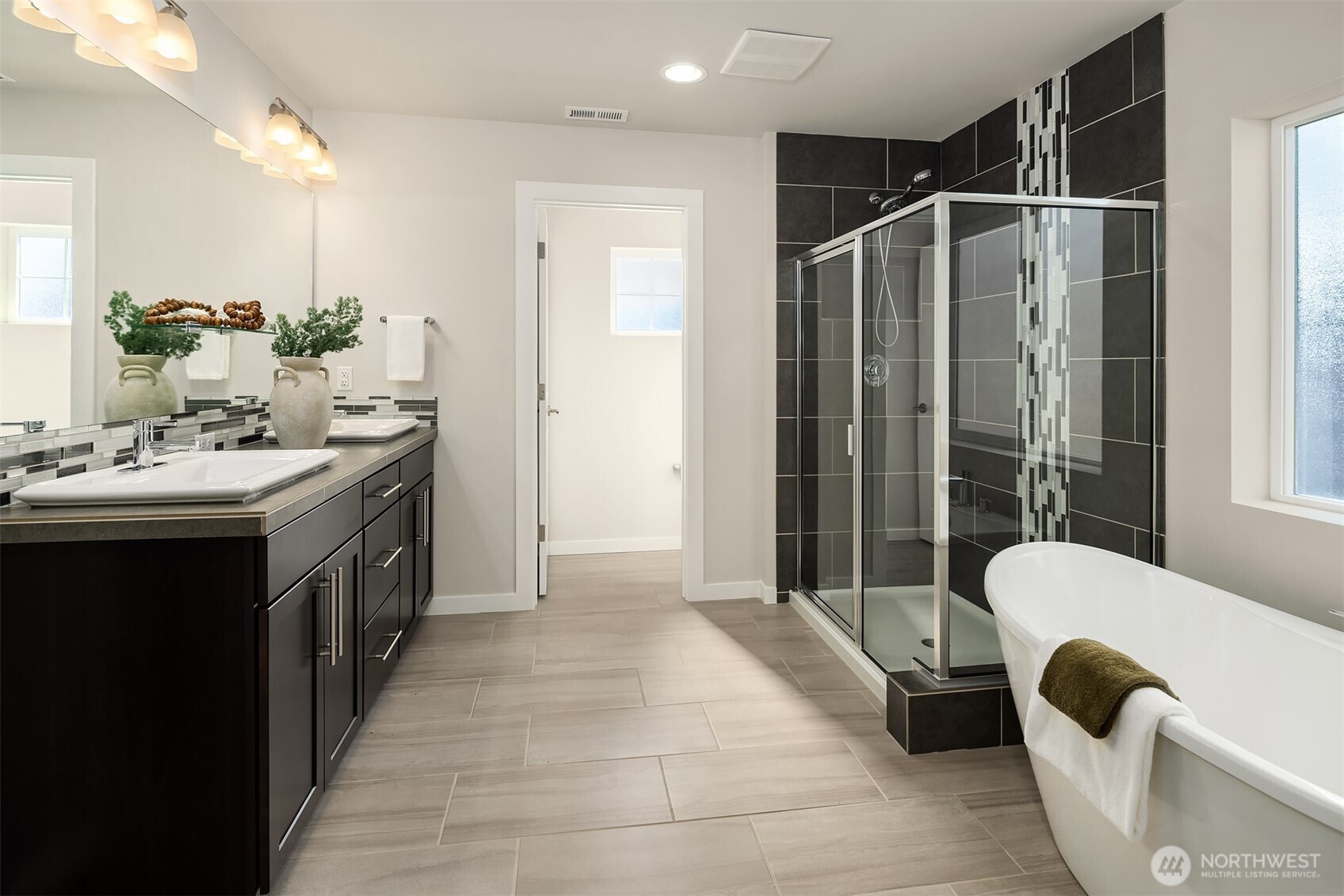 16911 125th Street Southeast Snohomish, WA 98290 - Photo 15 of 29 a spacious bathroom with a double vanity sink a large mirror and bathtub