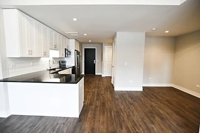 a kitchen with a refrigerator and a sink