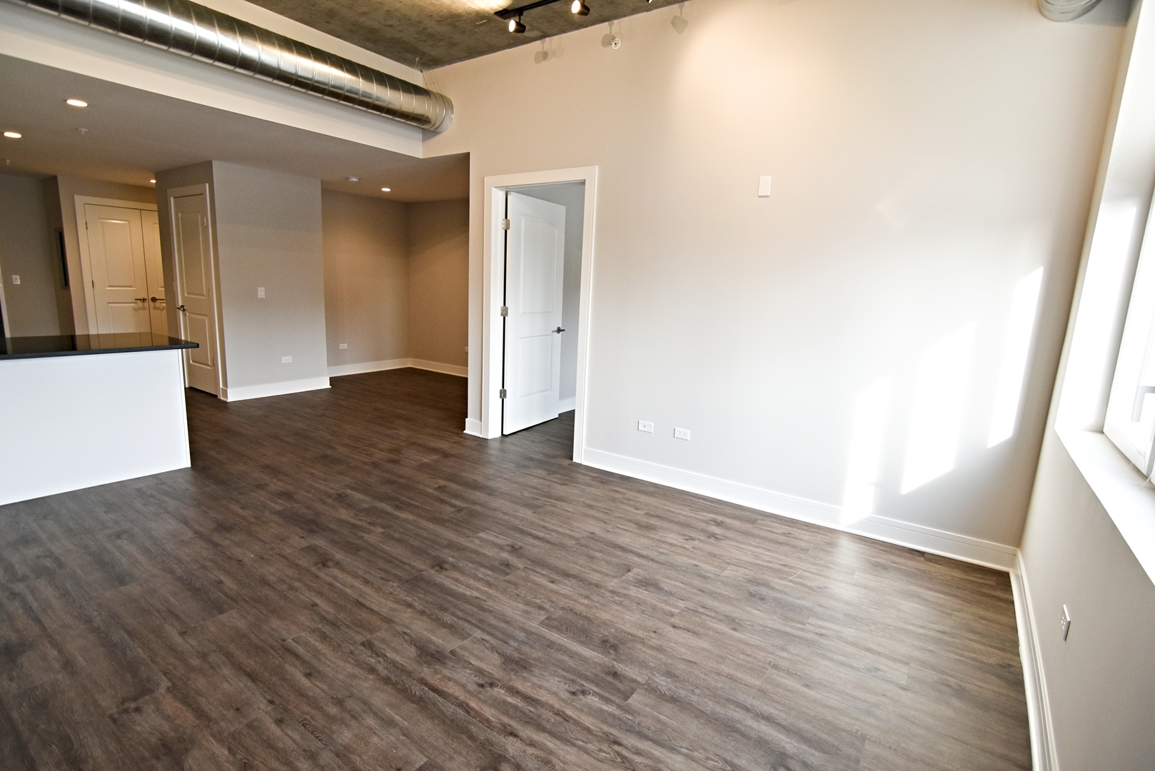 3833 North Broadway, Unit 720 Chicago, IL 60613 - Photo 4 of 11 a view of a hallway with wooden floor