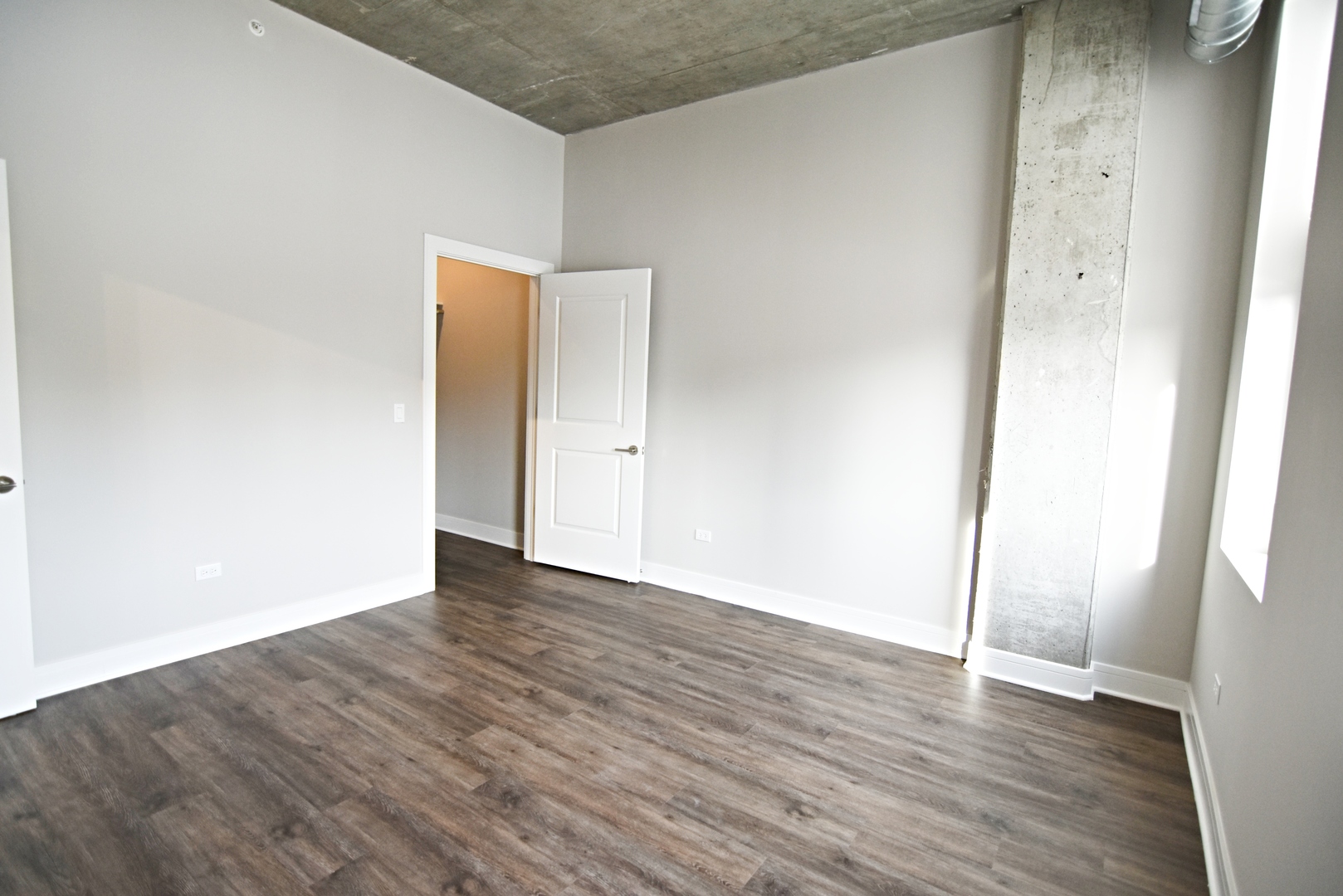 3833 North Broadway, Unit 720 Chicago, IL 60613 - Photo 10 of 11 an empty room with wooden floor and entrance