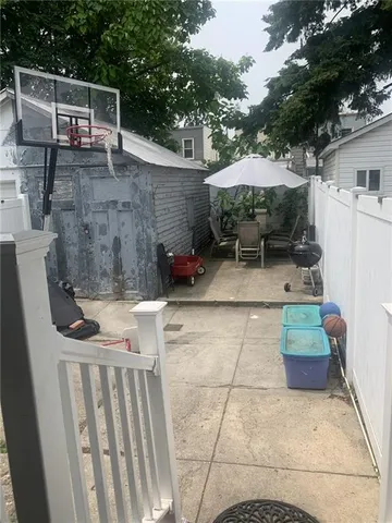 a view of a patio with table and chairs under an umbrella