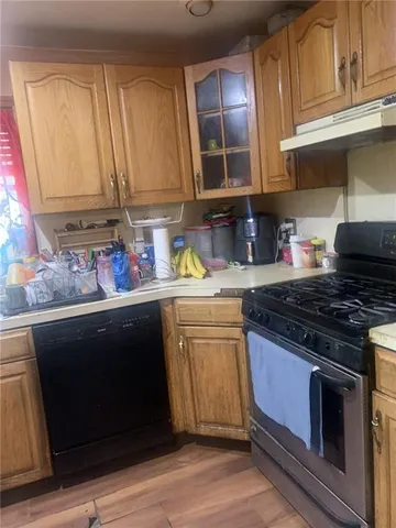 a kitchen with stainless steel appliances granite countertop a sink stove and cabinets