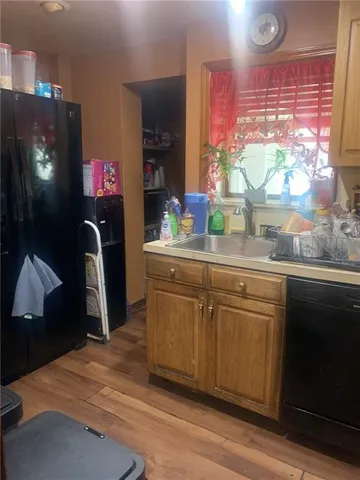a kitchen with stainless steel appliances granite countertop a sink window and cabinets