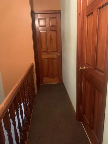 a bed with white sheets and pillows on it