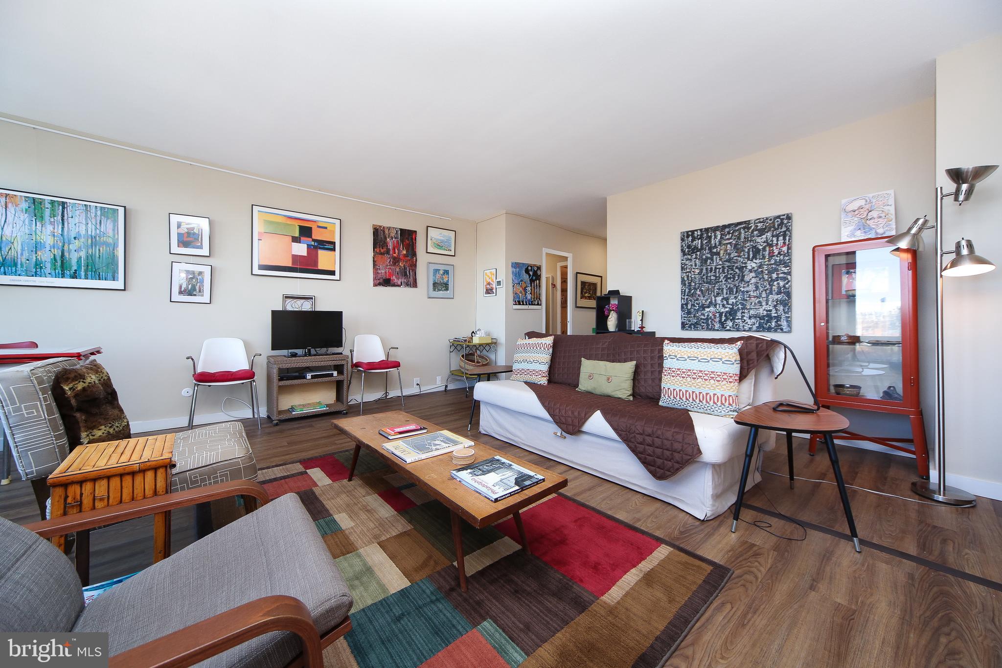 210 Locust Street, Unit 21E Philadelphia, PA 19106 - Photo 14 of 51 a living room with furniture and a rug