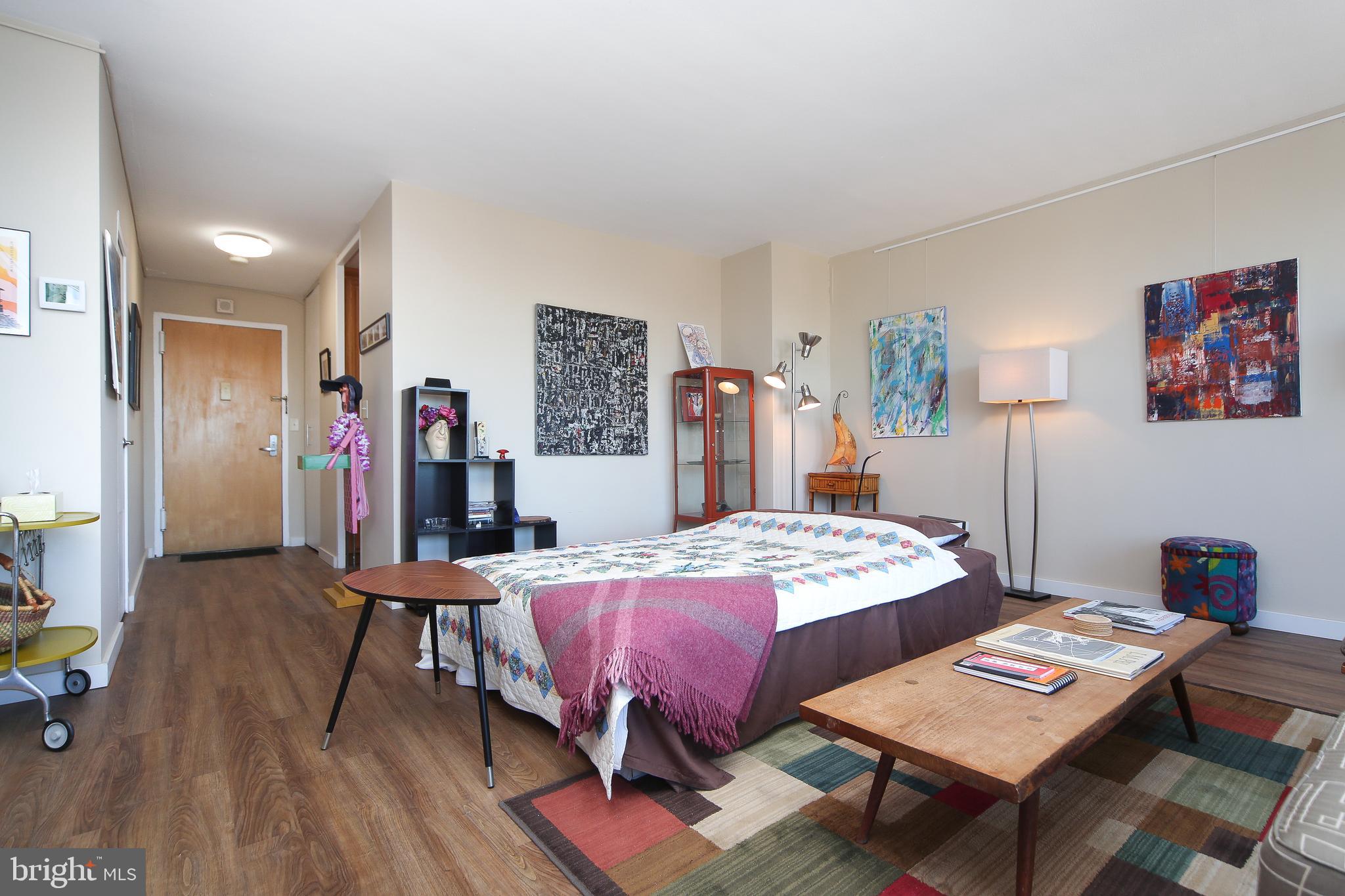 210 Locust Street, Unit 21E Philadelphia, PA 19106 - Photo 15 of 51 a bedroom with a bed and a table in it