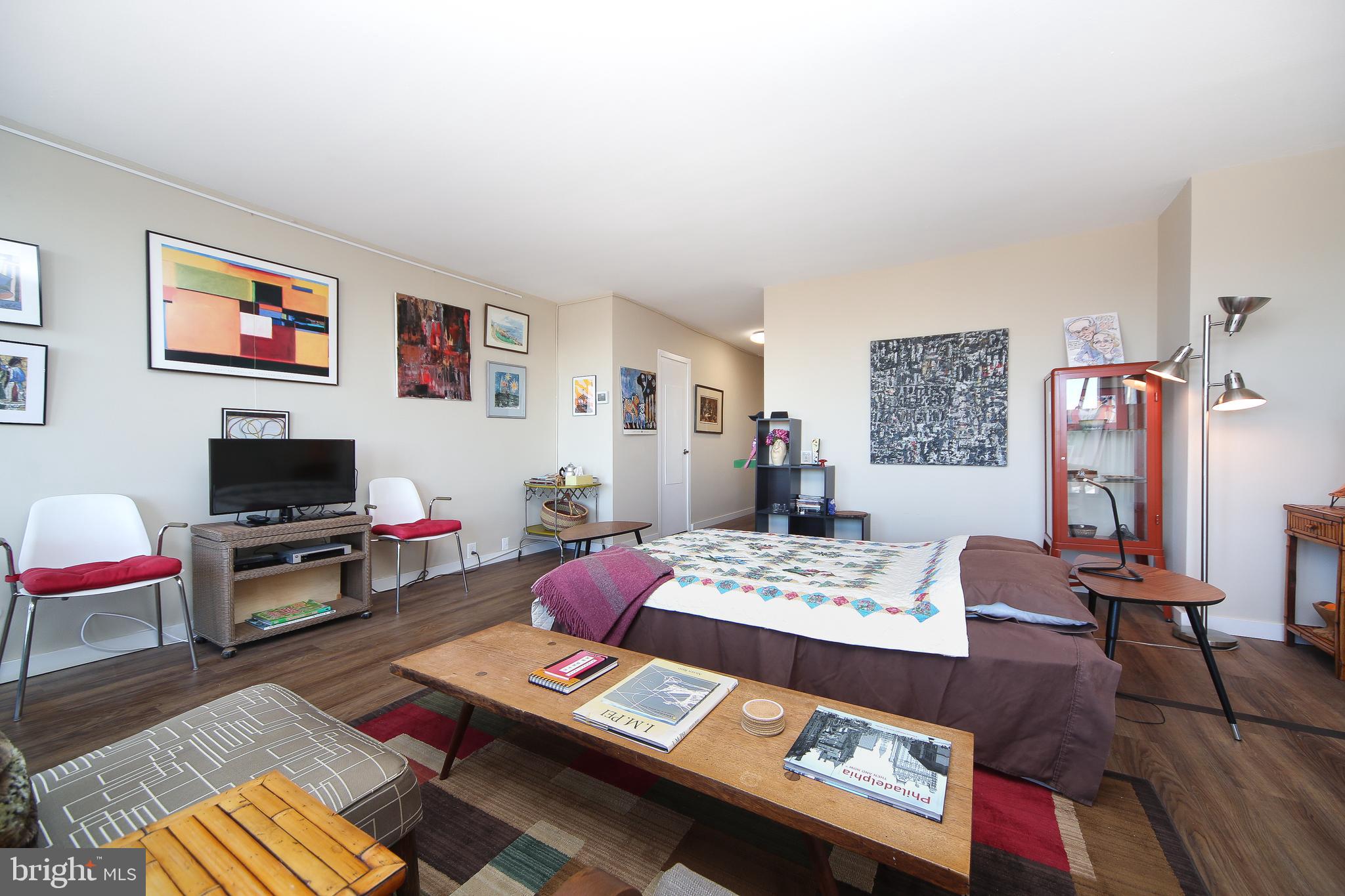 210 Locust Street, Unit 21E Philadelphia, PA 19106 - Photo 16 of 51 a living room with furniture and a flat screen tv