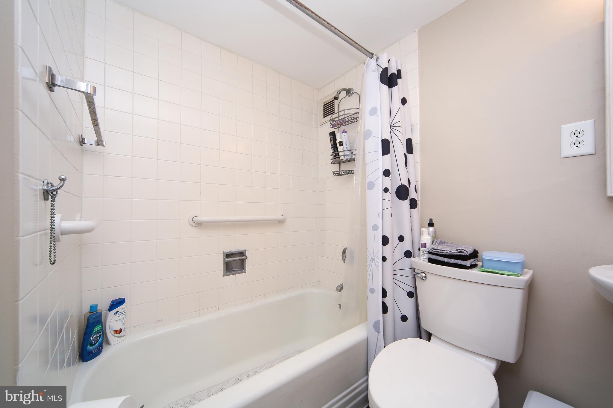 210 Locust Street, Unit 21E Philadelphia, PA 19106 - Photo 20 of 51 a white toilet sitting next to a bath tub
