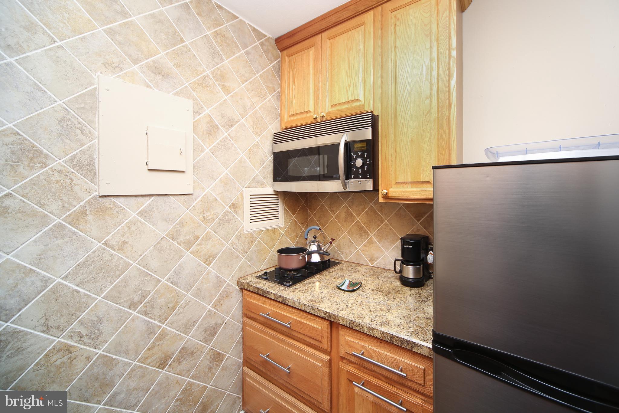 210 Locust Street, Unit 21E Philadelphia, PA 19106 - Photo 5 of 51 a kitchen with a sink a stove and cabinets