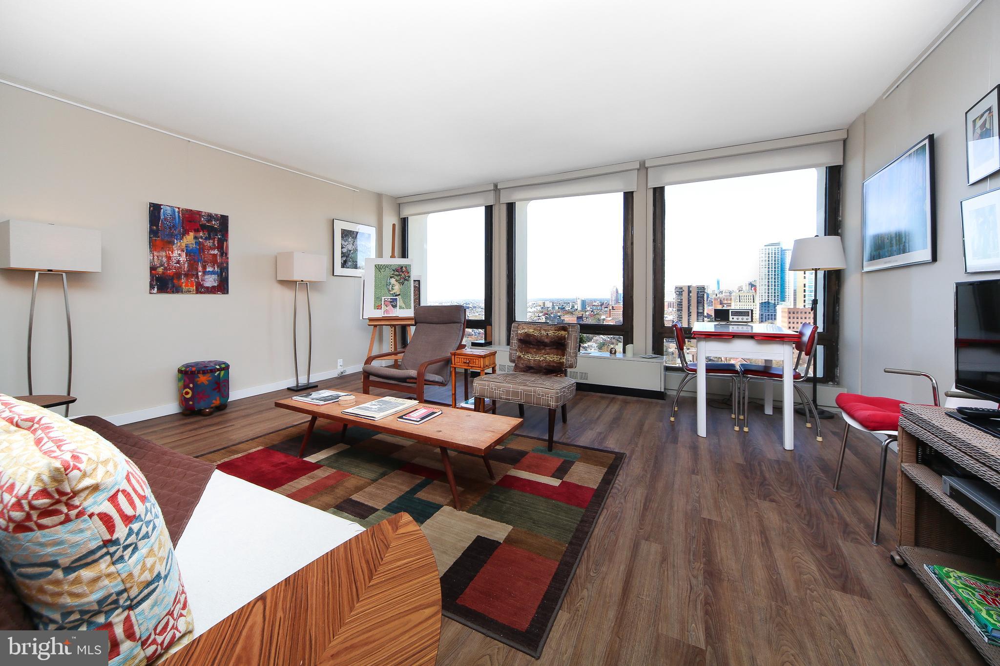 210 Locust Street, Unit 21E Philadelphia, PA 19106 - Photo 7 of 51 a living room with furniture and wooden floor