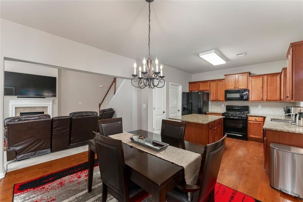 113 Tyson Woods Road Acworth, GA 30102 - Photo 19 of 37 a living room with furniture a flat screen tv and kitchen view
