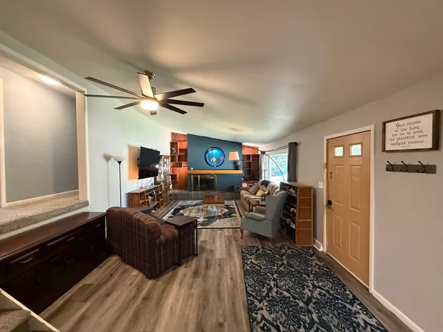 a bathroom with a sink a toilet a mirror a vanity and shower