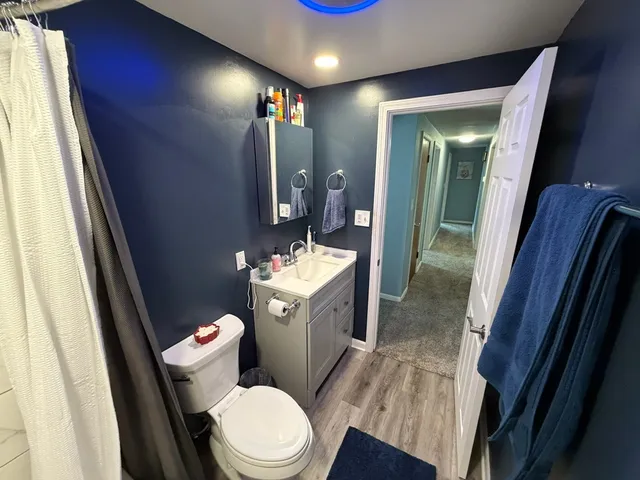 a bathroom with a sink mirror vanity and toilet