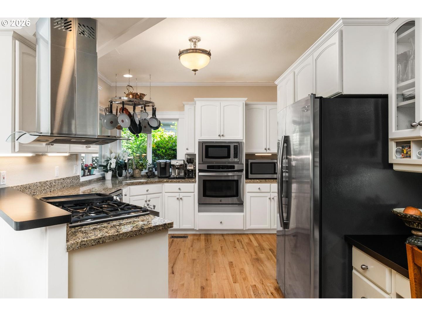 16042 Southwest Waxwing Way Beaverton, OR 97007 - Photo 9 of 48 a kitchen with stainless steel appliances a stove a sink and a refrigerator