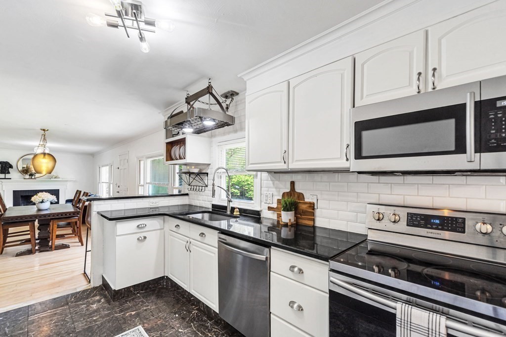 70 Embassy Road Springfield, MA 01119 - Photo 11 of 42 a kitchen with stainless steel appliances granite countertop a sink a stove and cabinets