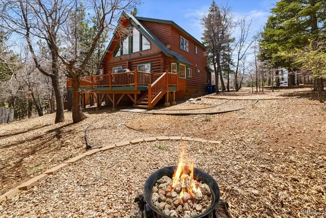 a view of a house with a yard covered in snow