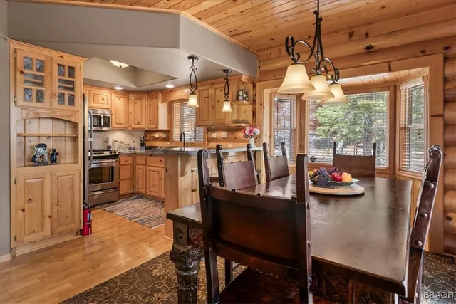 a kitchen with granite countertop a refrigerator stove and microwave
