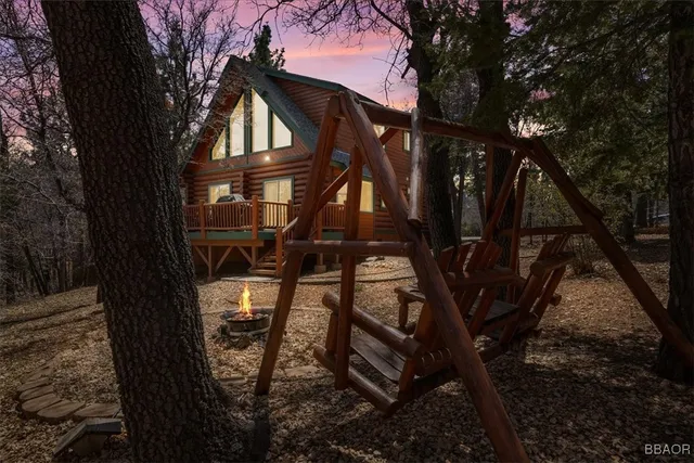 a view of a house with backyard and trees