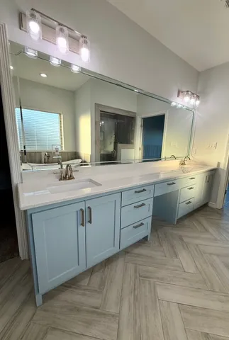 a view of a kitchen with fridge and wooden floor