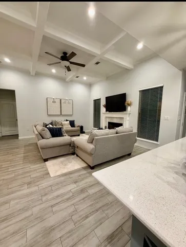 a living room with furniture and a wooden floor