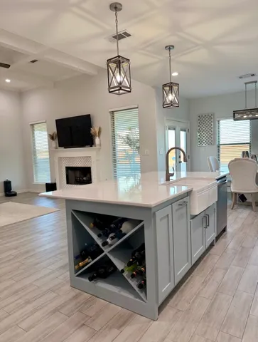 a kitchen with a sink cabinets and wooden floor