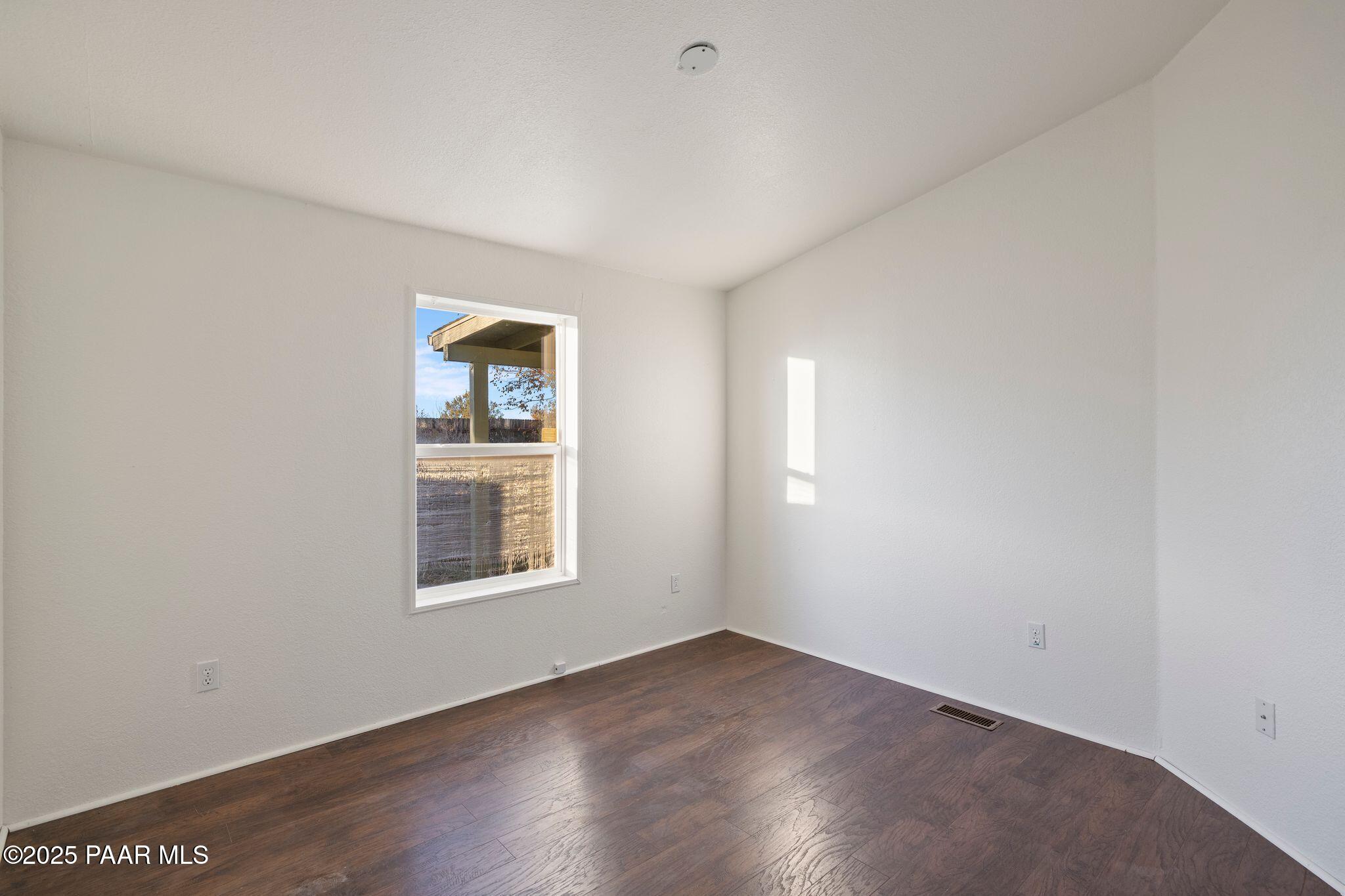 24580 North St Louis Street Paulden, AZ 86334 - Photo 12 of 26 an empty room with wooden floor and windows