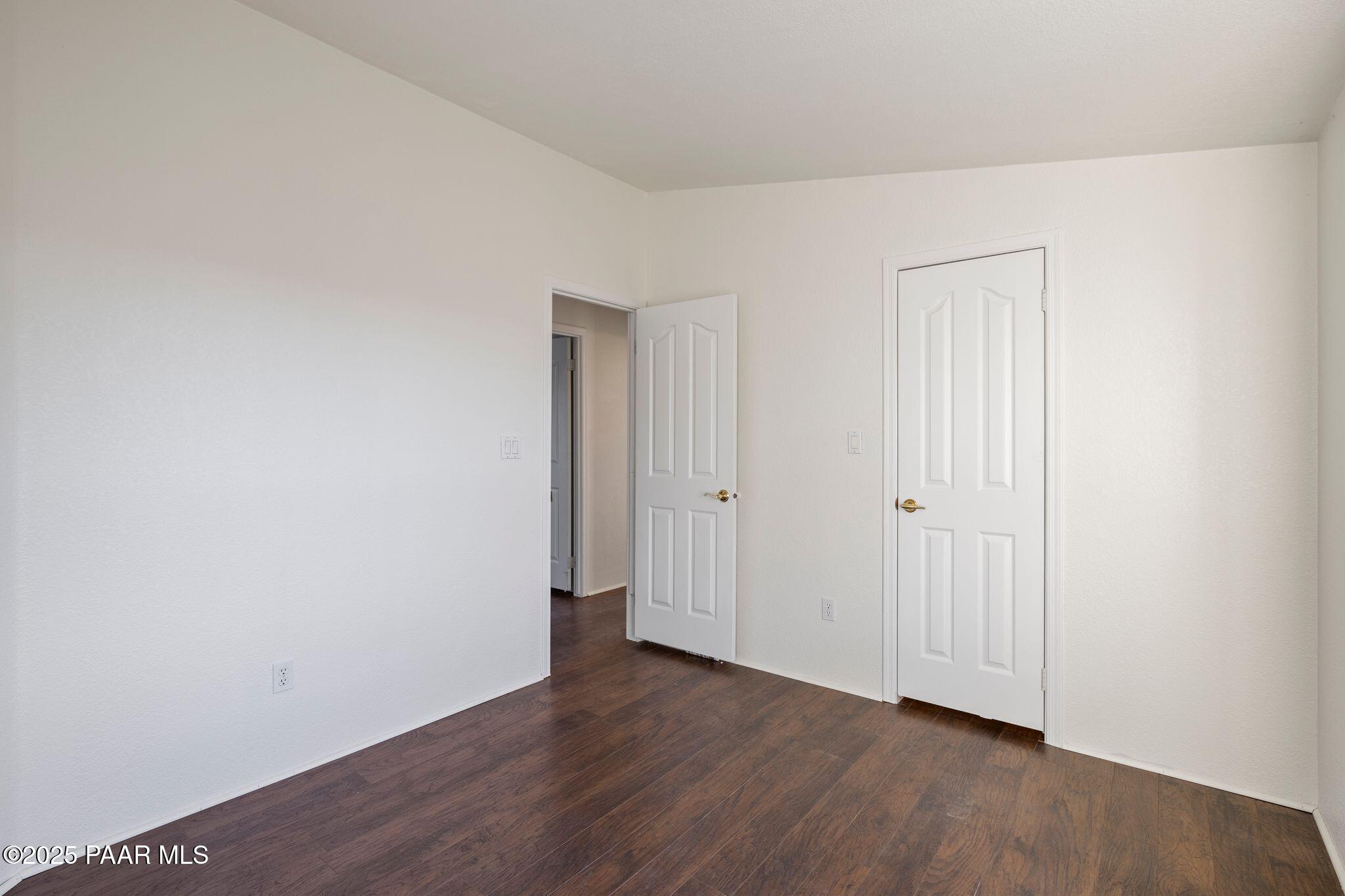 24580 North St Louis Street Paulden, AZ 86334 - Photo 13 of 26 a view of an empty room with wooden floor