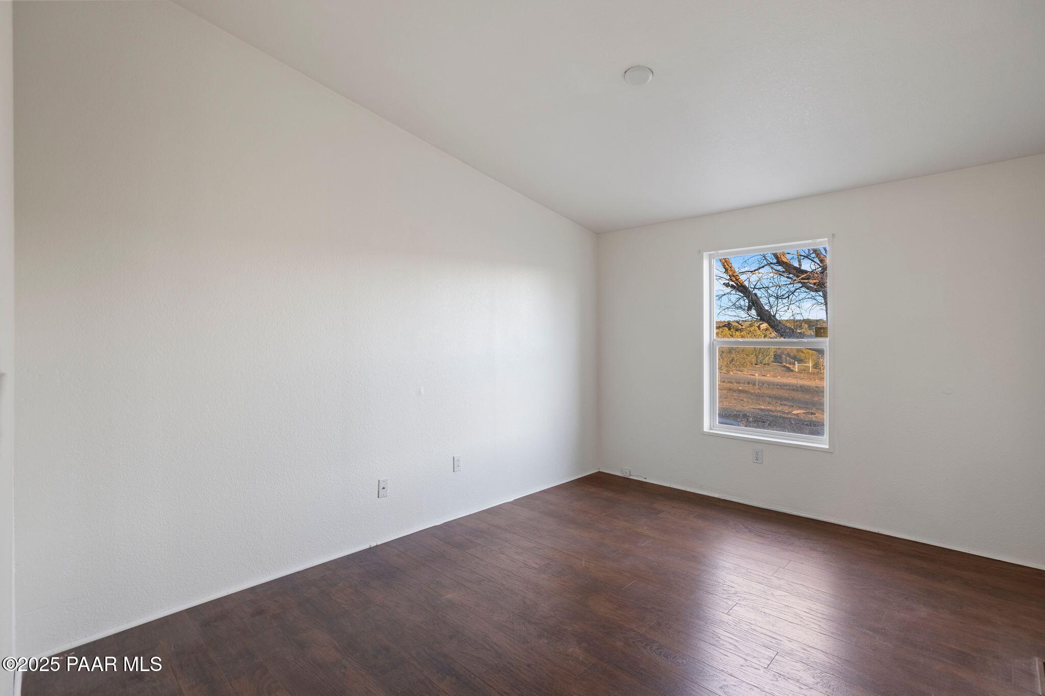 24580 North St Louis Street Paulden, AZ 86334 - Photo 15 of 26 an empty room with wooden floor and windows