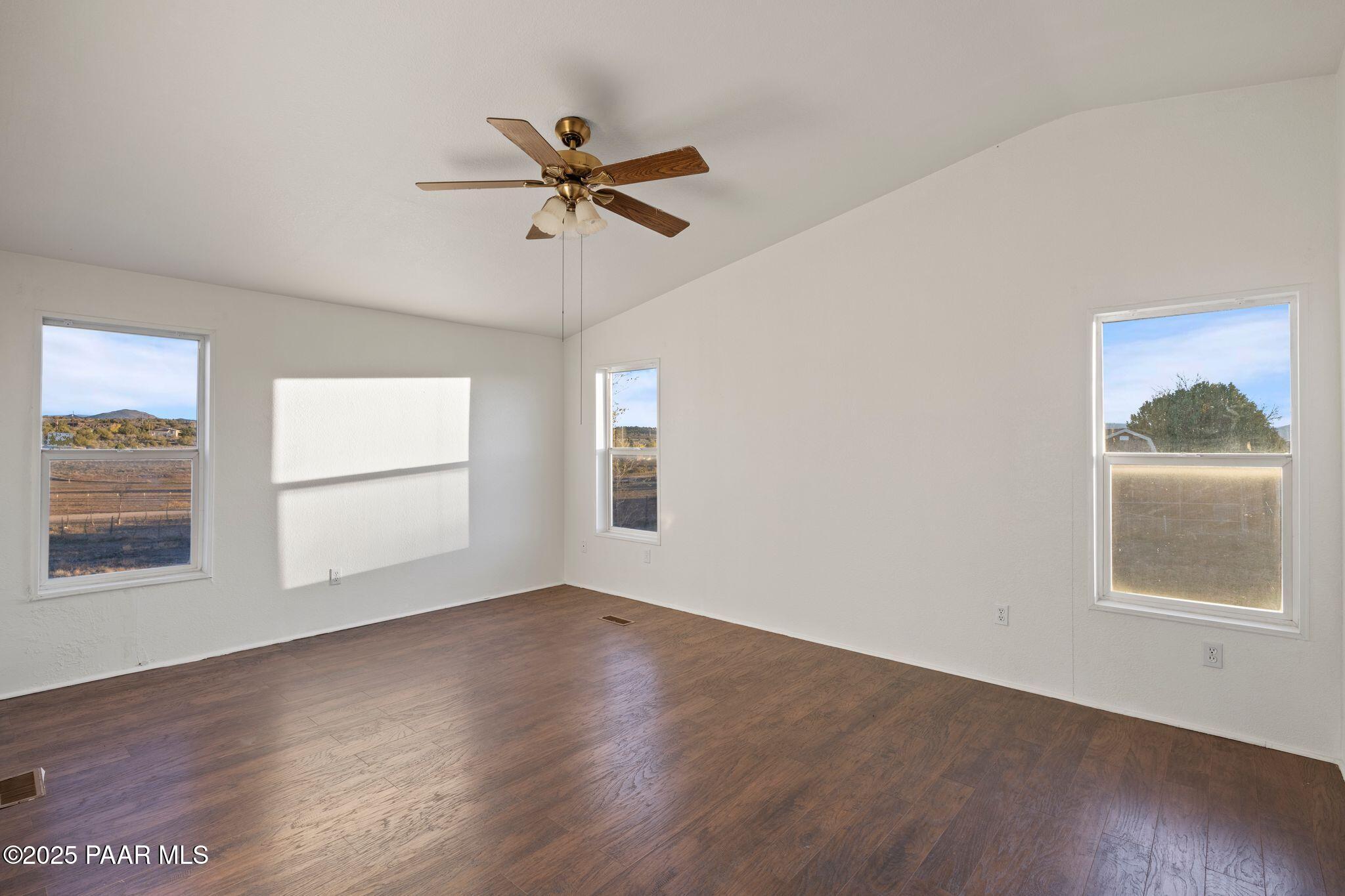 24580 North St Louis Street Paulden, AZ 86334 - Photo 18 of 26 a view of empty room with wooden floor and fan