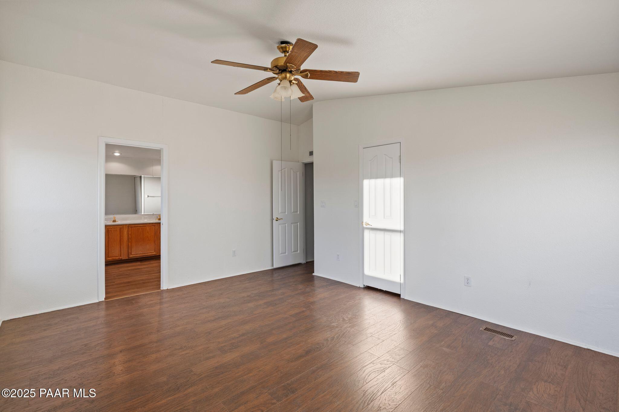 24580 North St Louis Street Paulden, AZ 86334 - Photo 19 of 26 an empty room with wooden floor closet and windows