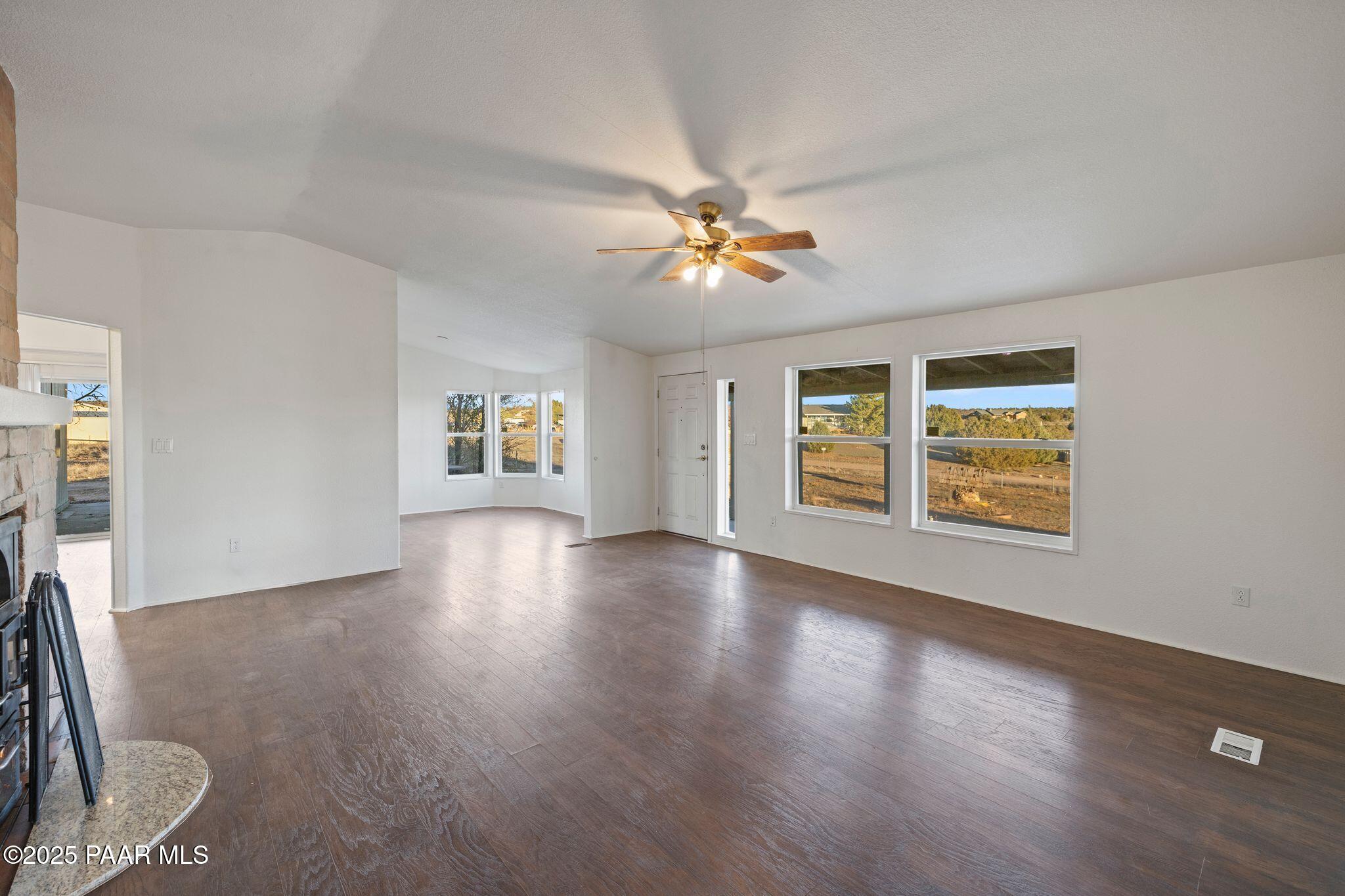 24580 North St Louis Street Paulden, AZ 86334 - Photo 5 of 26 a view of an empty room with a window and wooden floor