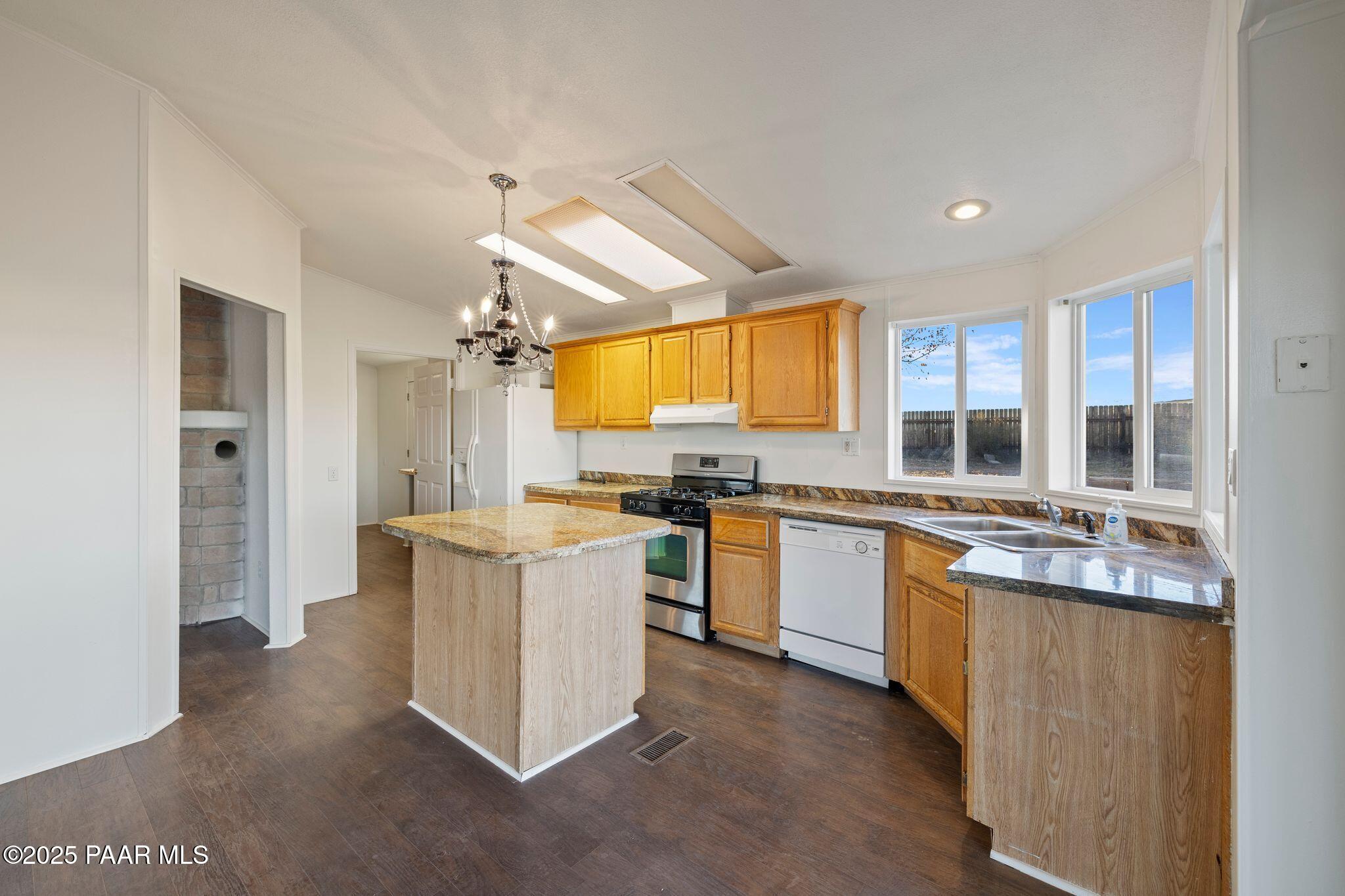 24580 North St Louis Street Paulden, AZ 86334 - Photo 9 of 26 a kitchen that has a lot of white cabinets and stainless steel appliances