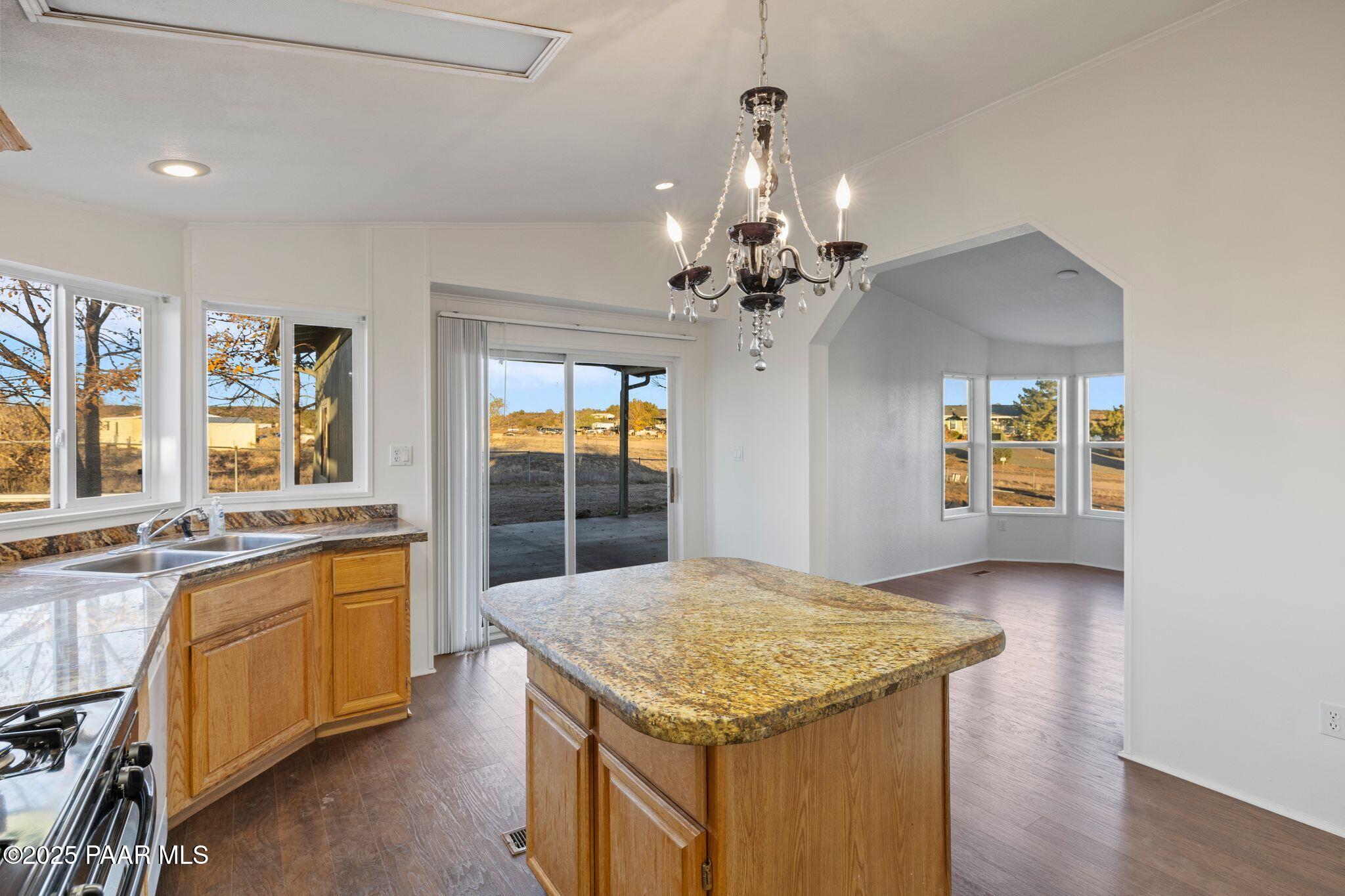 24580 North St Louis Street Paulden, AZ 86334 - Photo 10 of 26 a kitchen with a stove and chandelier