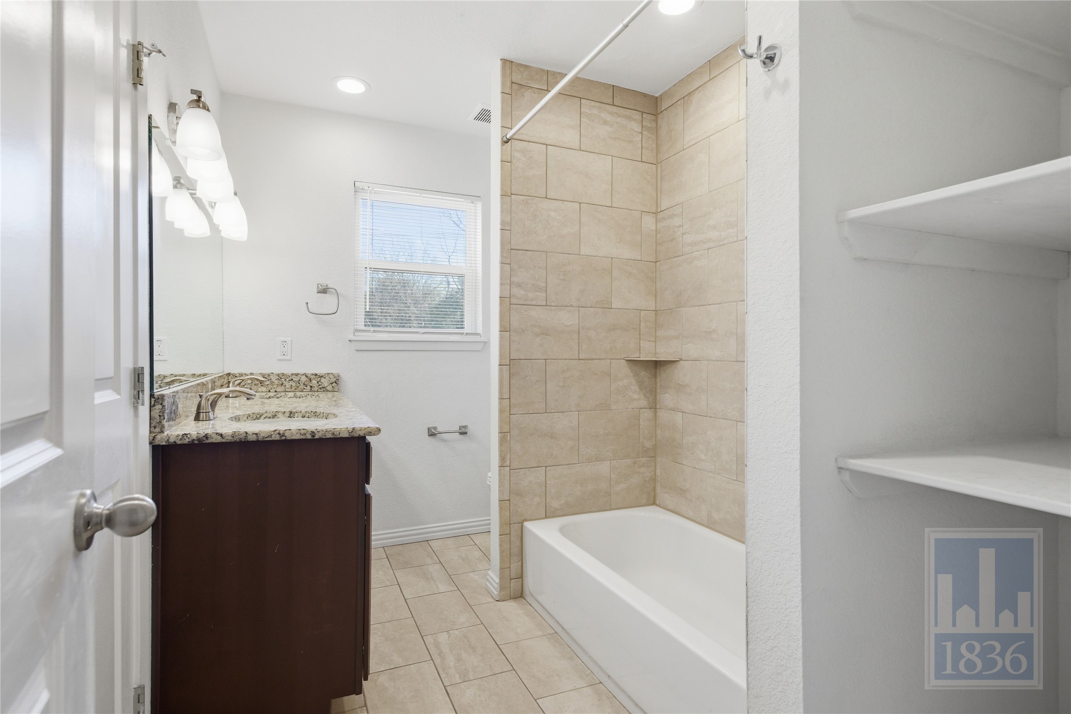4405 Terrilance Drive Austin, TX 78741 - Photo 18 of 36 a bathroom with a bathtub a sink and a shower
