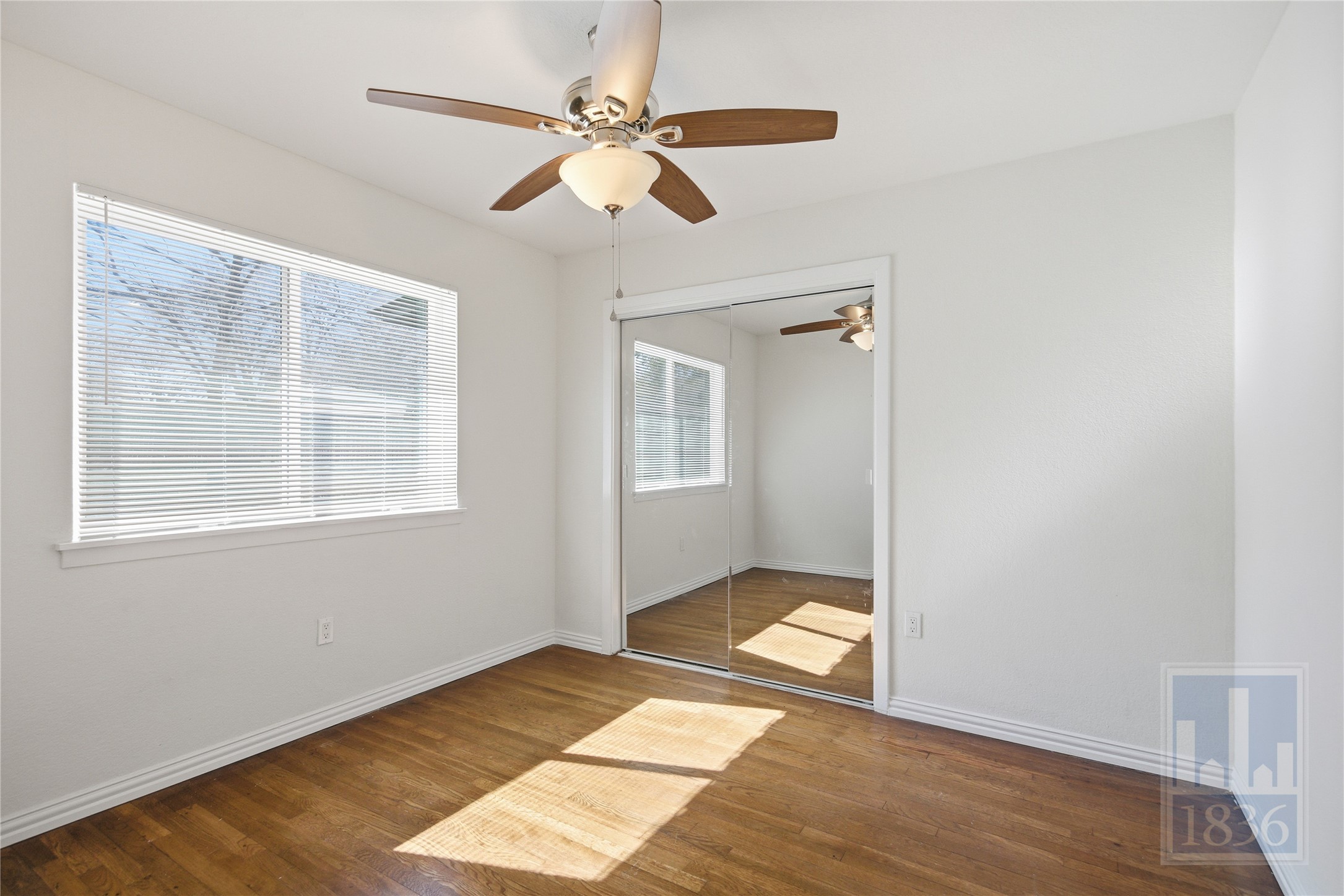 4405 Terrilance Drive Austin, TX 78741 - Photo 23 of 36 a view of an empty room with wooden floor and a window