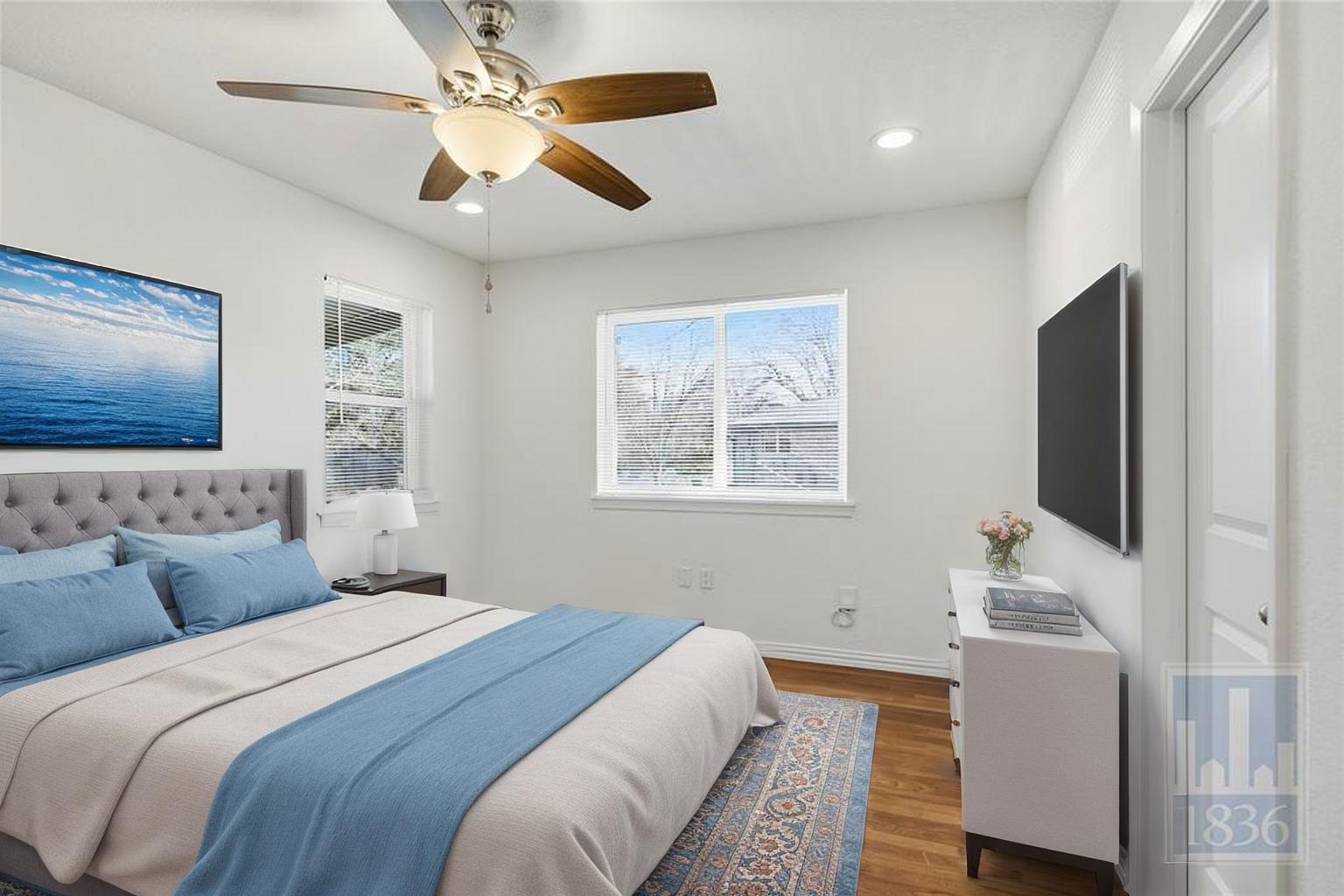 4405 Terrilance Drive Austin, TX 78741 - Photo 3 of 36 a bedroom with a bed and a flat screen tv