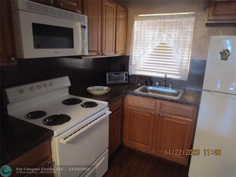 a kitchen with a stove microwave and sink