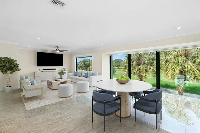 a view of a living room hardwood floor and a large window