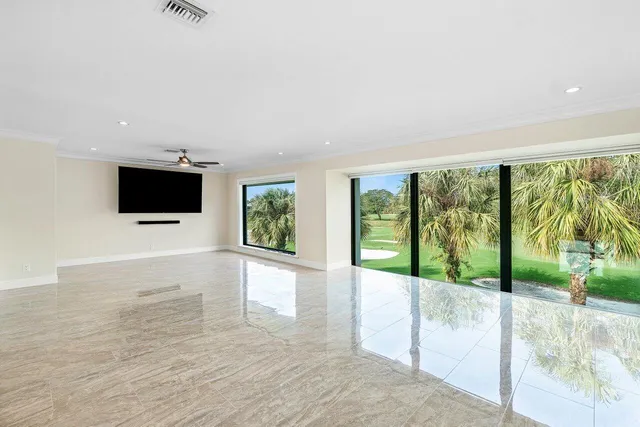 a view of an empty room with glass door