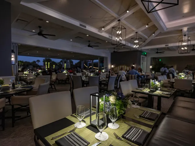 a view of a house with a yard and potted plants