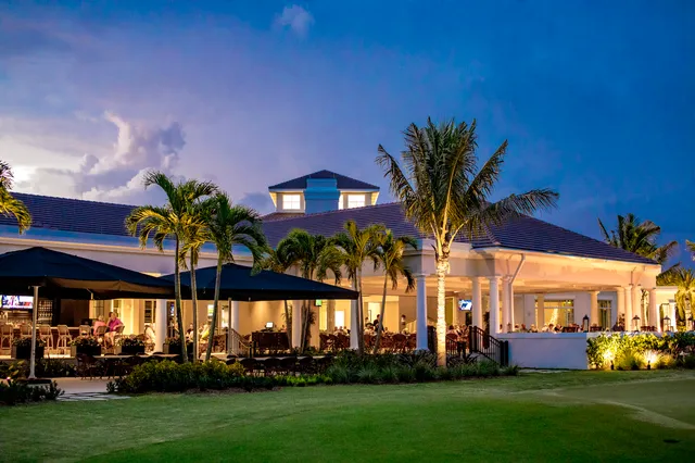 a view of a swimming pool with a yard and plants