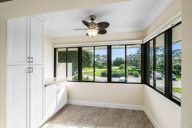 a bathroom with a large tub and a large window