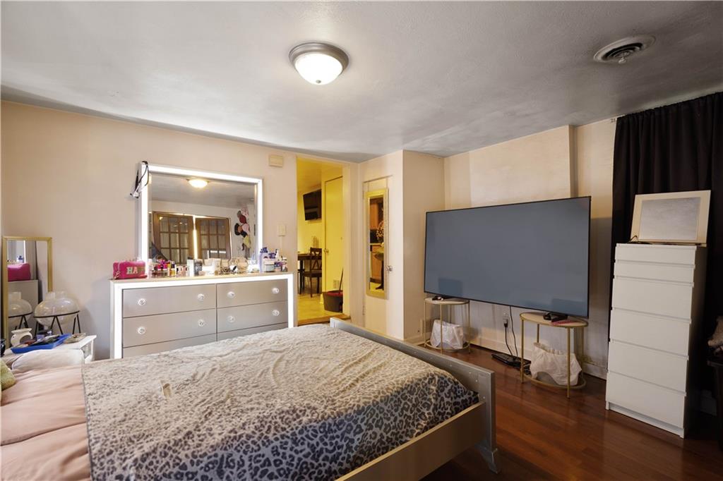 108 Pius Street Pittsburgh, PA 15203 - Photo 11 of 36 a bedroom with a bed and a flat screen tv